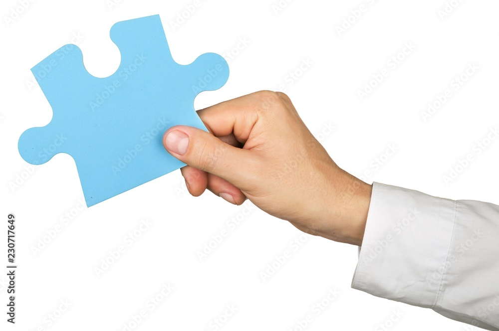 Businessman Hand Holding a Puzzle Piece Businessman Hand Holding a Puzzle Piece