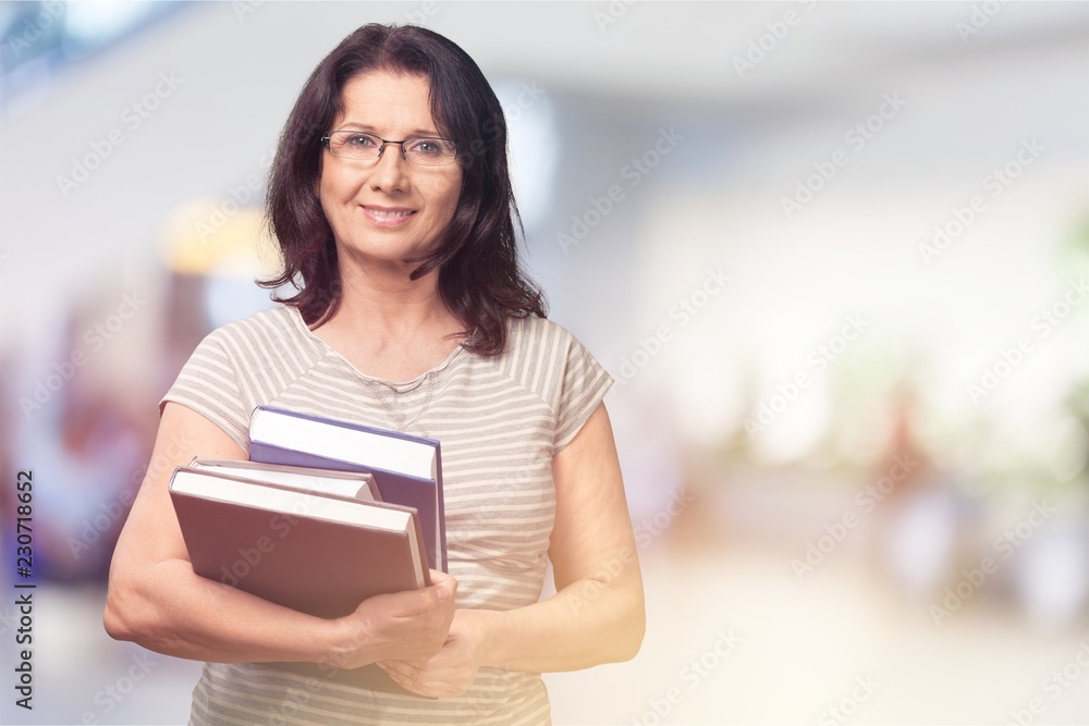 Woman with heap of books on blue background Woman with heap of books on blue background