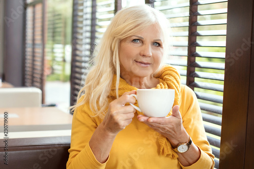 Beautiful senior woman drinking cofee.