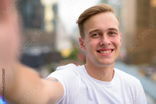Personal point of view of handsome man taking selfie with phone