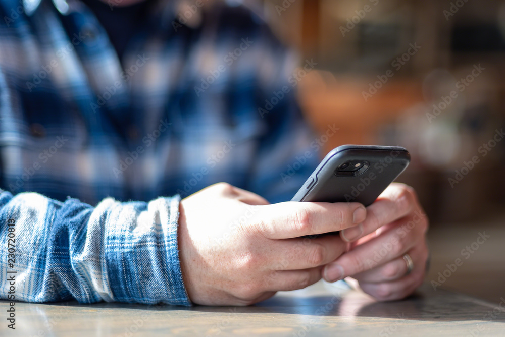 Man using cell phone - hands only Man using cell phone - hands only