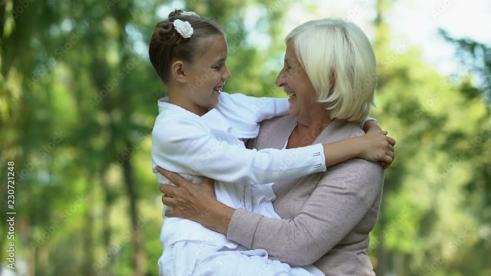 Beloved granddaughter sitting on grandmothers laps, trusting relations, family Beloved granddaughter sitting on grandmothers laps, trusting relations, family