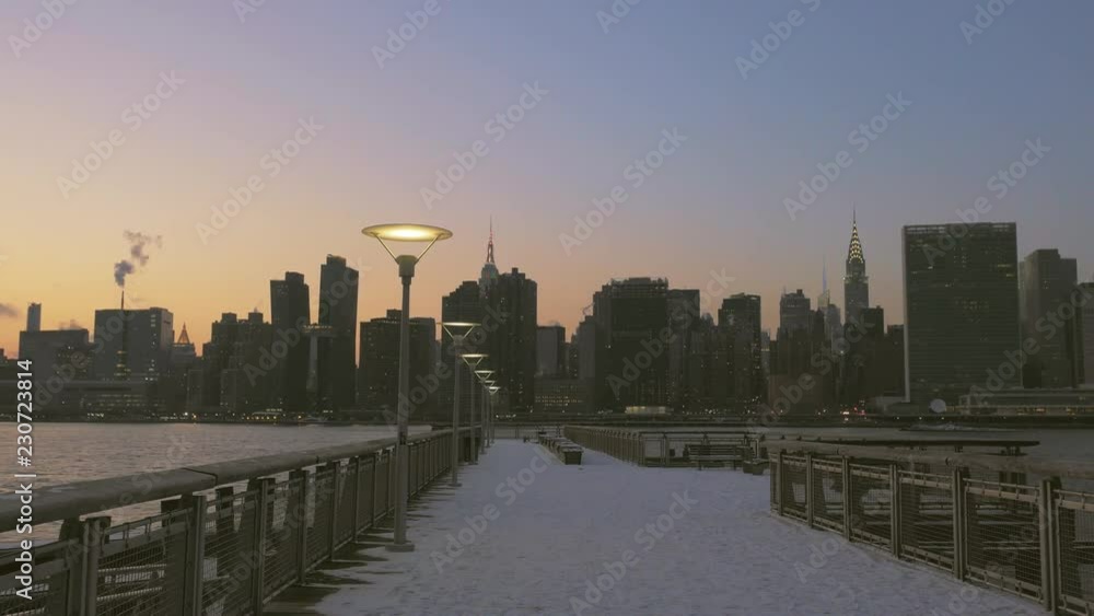 View down snow-covered Long Island City Pier at Dusk with Manhattan Skyline across East River, Gantry Plaza State Park, LIC View down snow-covered Long Island City Pier at Dusk with Manhattan Skyline across East River, Gantry Plaza State Park, LIC