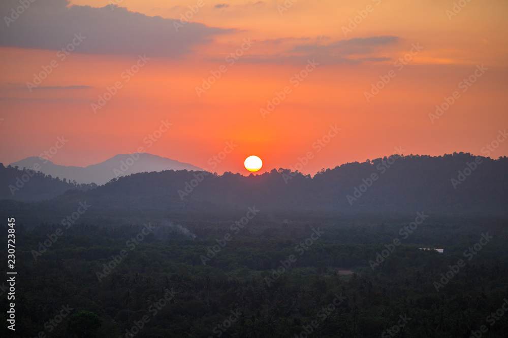 The background of the big sun, which is going to hide the mountains, and the light of the evening light, beautiful colors, beautiful nature of the season. The background of the big sun, which is going to hide the mountains, and the light of the evening light, beautiful colors, beautiful nature of the season.