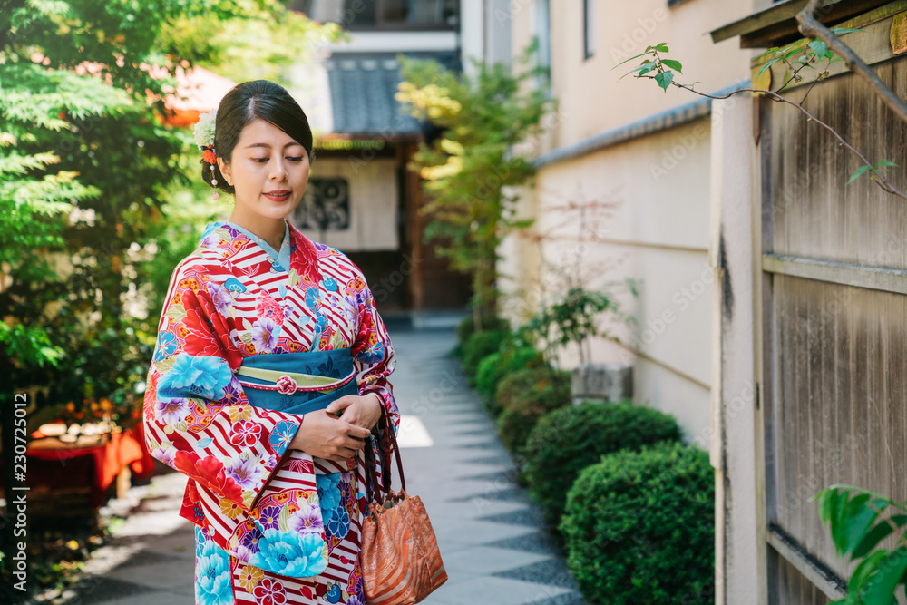 Japanese lady standing in garden in sunny day Japanese lady standing in garden in sunny day