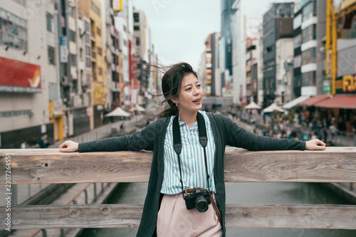 tourist relaxing relying on the wooden bridge photo