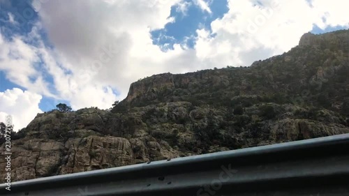 Panning timelapse of clouds rolling over mountains. photo