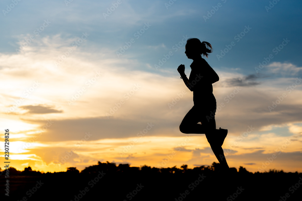 silhouette woman running alone at beautiful sunset in the park.