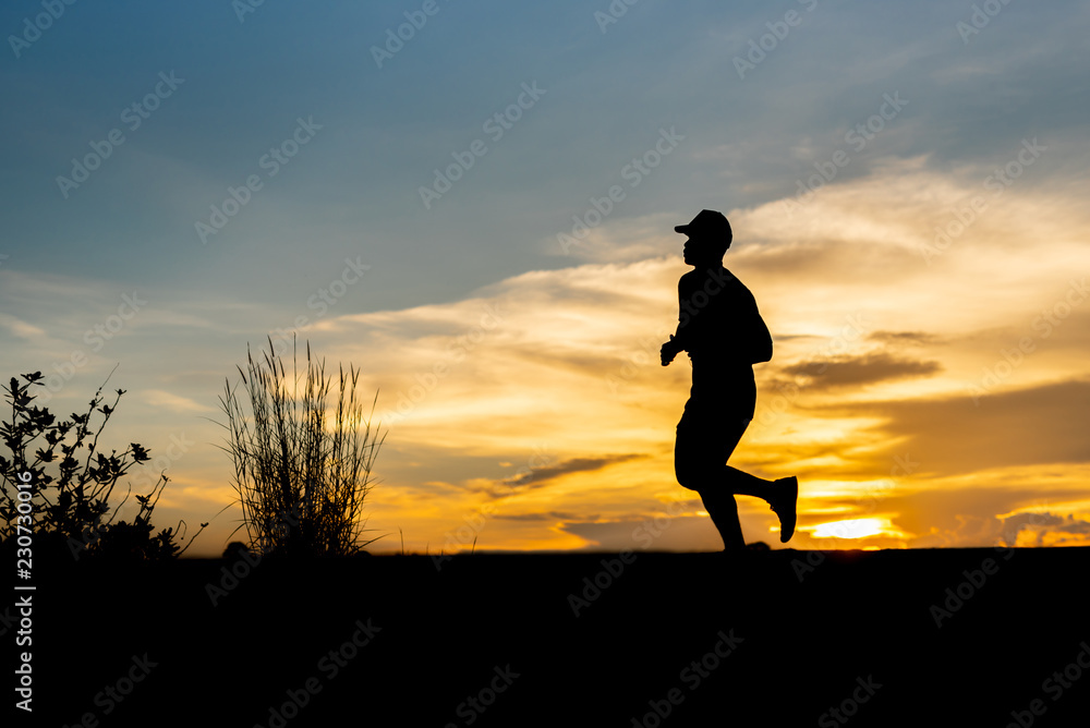 silhouette running alone at beautiful sunset in the park.