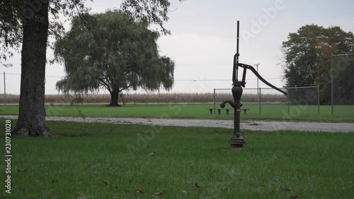 Old metal water pump on an overcast evening before dusk at Seims Park in Union, IL. photo