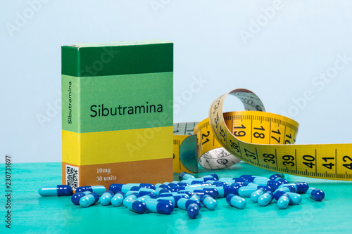 colored capsule of medication in transparent plastic storage container photo