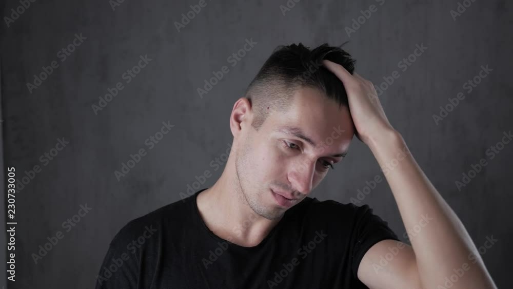 Closeup portrait of young stylish man at gray background Closeup portrait of young stylish man at gray background