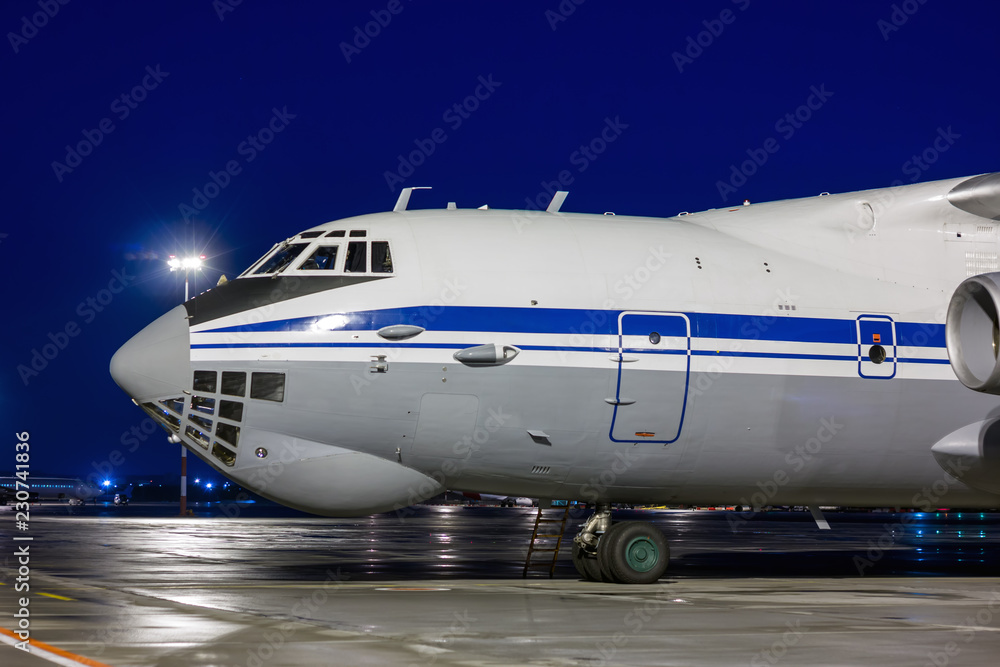 Close-up big cargo aircraft at the airport apron in the night