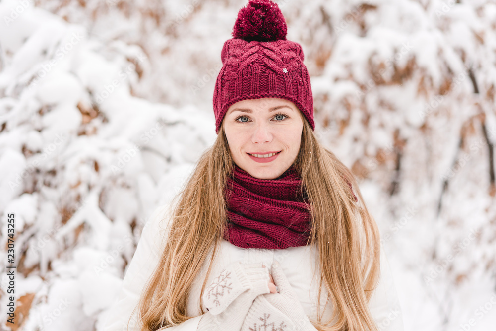 Smiling young woman outdoors in a winter forest Smiling young woman outdoors in a winter forest