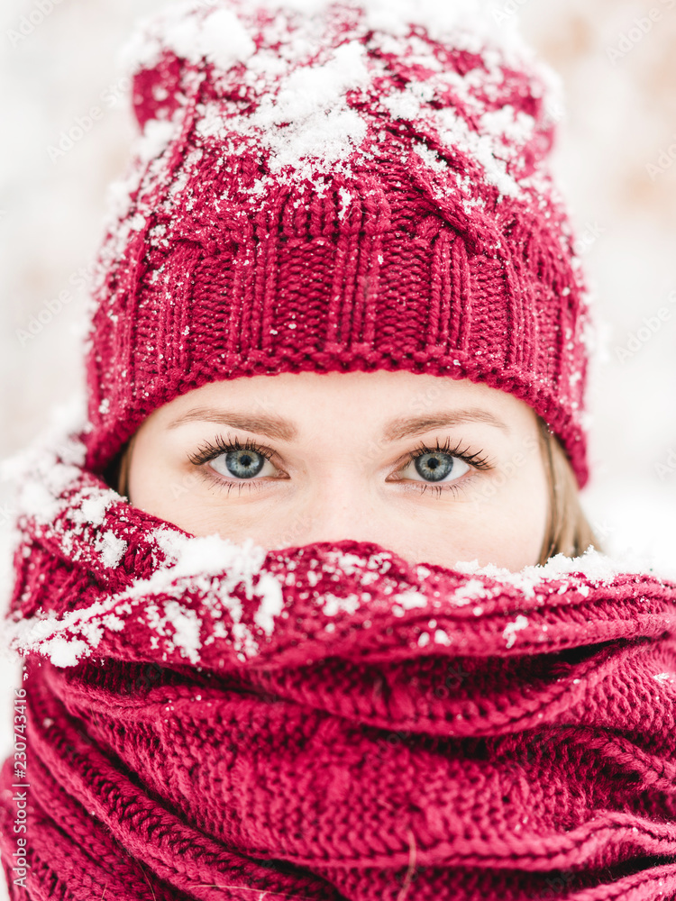 Close up portrait of a young woman with red hat and scarf Close up portrait of a young woman with red hat and scarf