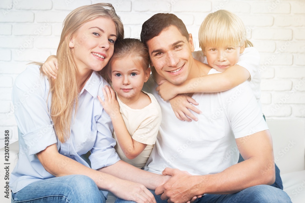 Beautiful smiling family in room on couch Beautiful smiling family in room on couch