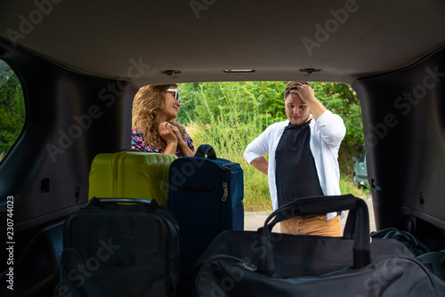 couple put bags in car trunk © phpetrunina14