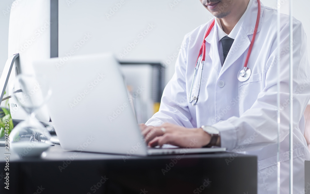 Young asian doctor sit and hard work with computer Young asian doctor sit and hard work with computer