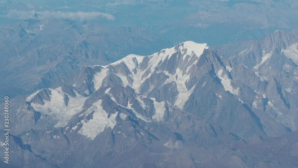 Flying over the Alps during fall season. Amazing landscape at the Mont Blanc and Its glaciers. Aerial view from the airplane window Flying over the Alps during fall season. Amazing landscape at the Mont Blanc and Its glaciers. Aerial view from the airplane window