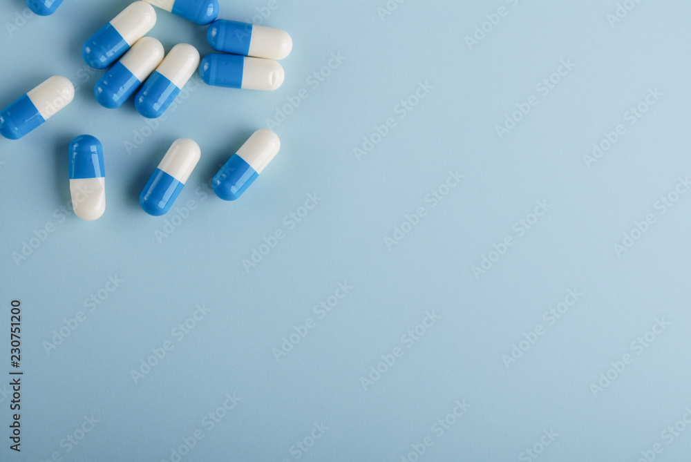 Blue and white capsules on blue