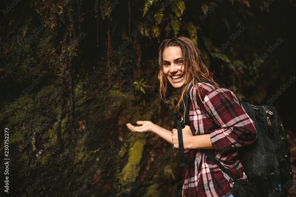 Cheerful woman enjoying a hike in rain forest Cheerful woman enjoying a hike in rain forest