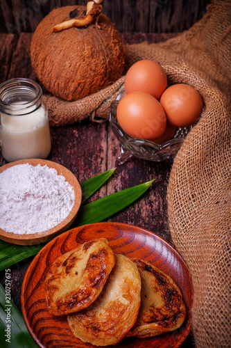 Akok Kedut, egg, coconut, flour , coconut milk and  Pandan leaf on wooden background. Akok Kedut is a traditional dish in Malaysia especially East Coast. photo