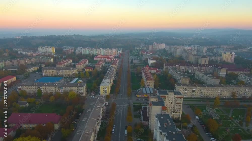 Aerial view from Drone: Small town with a road and cars, houses and parking lots. Aerial view from Drone: Small town with a road and cars, houses and parking lots.