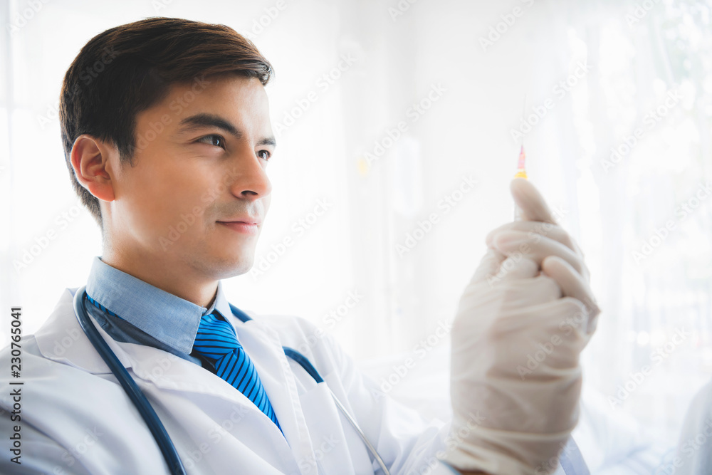 Photo of Professional doctor holding syringe in hand. Preparing for vaccination at hospital. Photo of Professional doctor holding syringe in hand. Preparing for vaccination at hospital.
