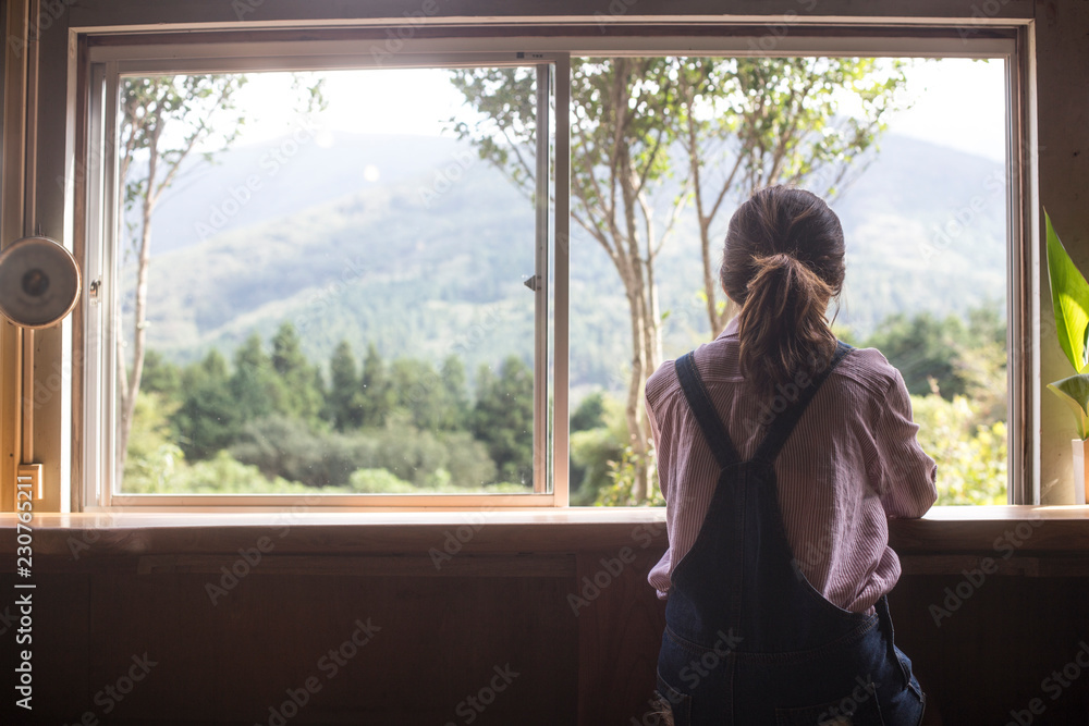 woman looking out the window woman looking out the window