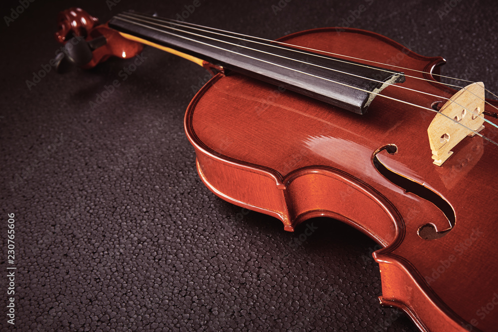 part of a violin on a black background with hard light part of a violin on a black background with hard light