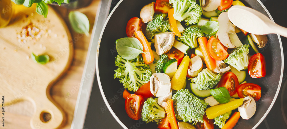 Man cooking fresh vegetables on pan Man cooking fresh vegetables on pan