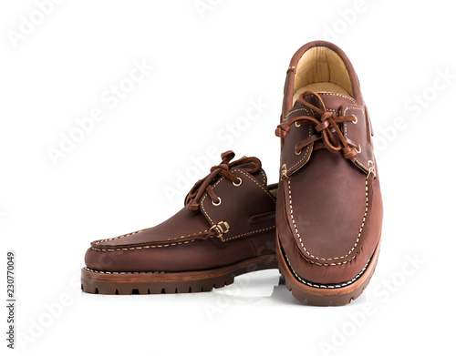 Brown oil full grain men’s boat shoes isolated on white background. Fashion advertising shoes photos.
