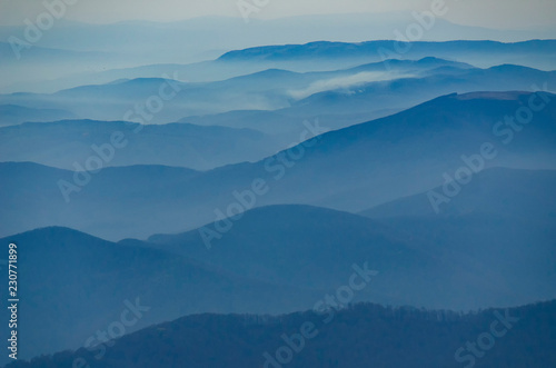 Beautiful morning alpine landscape with tonal perspective in blue tonality © Mny-Jhee