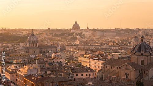 Panorama of Rome with the Dome of St. Peter's Basilica and the the Vatican City in golden Light at sunset. 