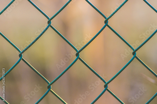 Diamond-shaped steel mesh fence close-up background