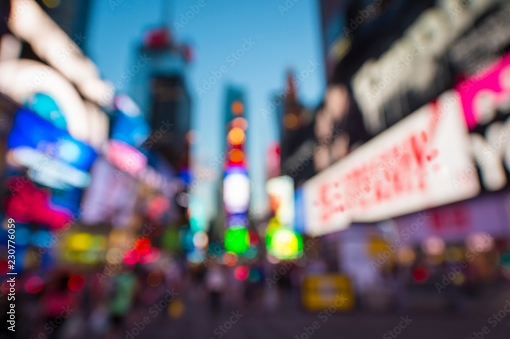 Fototapeta premium Abstract bokeh view of Times Square with glowing lights, traffic, and crowds under bright dusk sky in New York City, USA