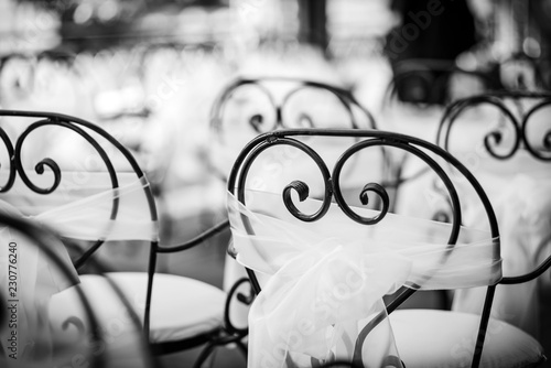 Vintage styled chairs with a white decoration for a special event photo