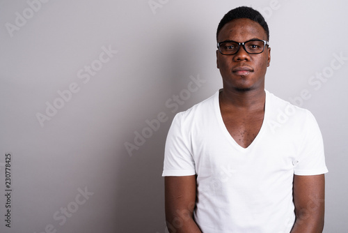 Portrait of young African man against white background