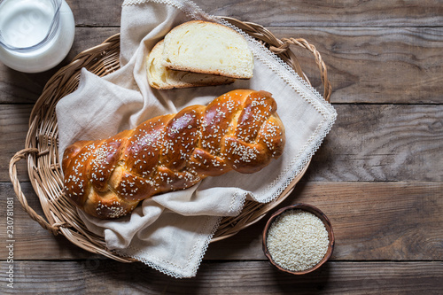 traditional Jewish challah bread on wooden background from boards