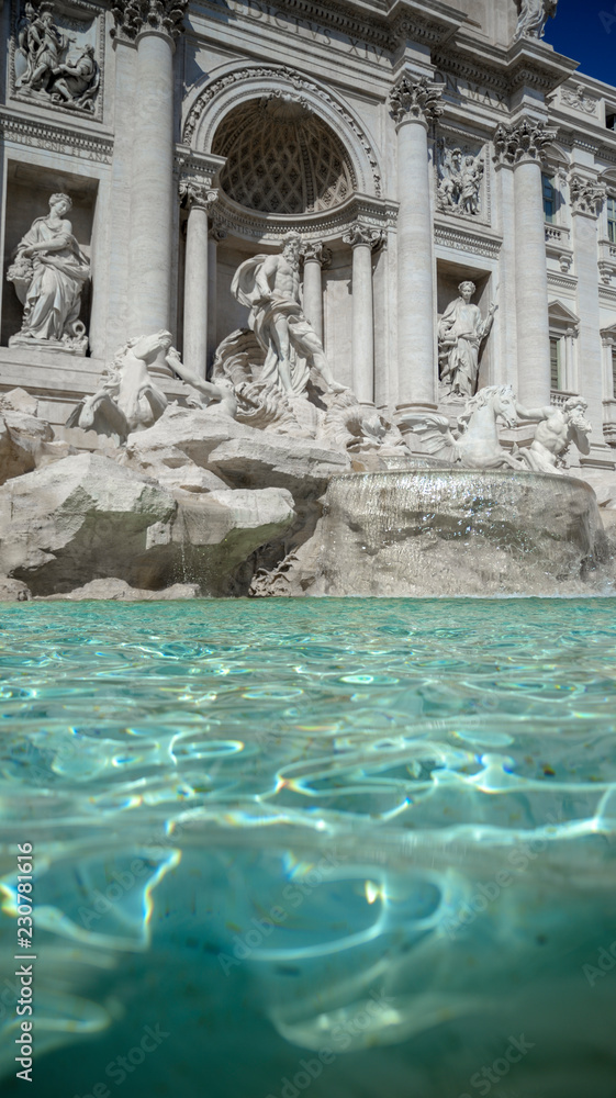 The Trevi Fountain. In the foreground coins that tourists throw into the fountain. Rome Italy