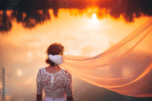 Beautiful bride and orange sunset
