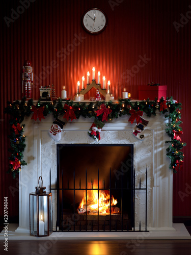 view of nice white christmas decorated fireplace  with candles in it