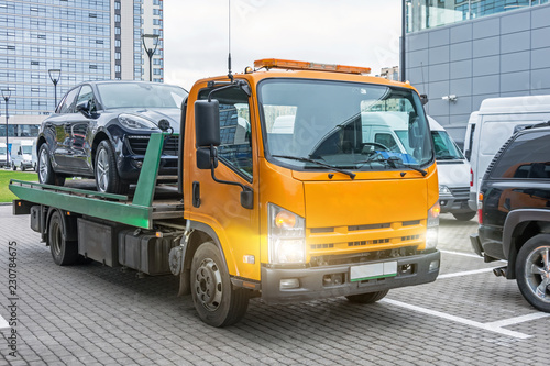 Hatchback car loaded onto a tow truck ready for transport.