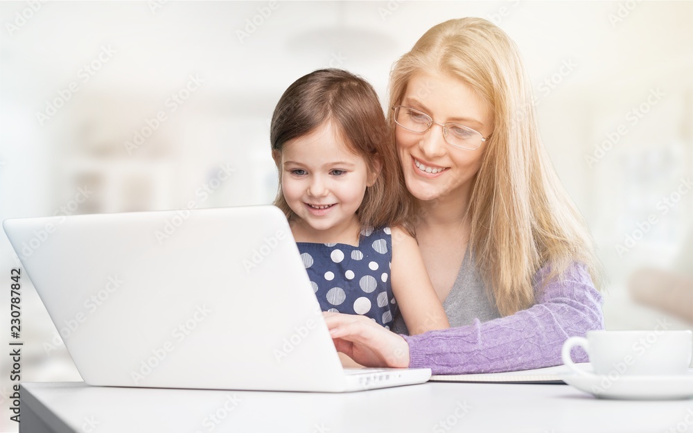 Happy mother with dauther using laptop at home Happy mother with dauther using laptop at home
