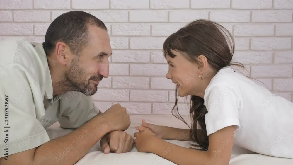 Father plays with the child. Father and daughter look at each other. Father plays with the child. Father and daughter look at each other.