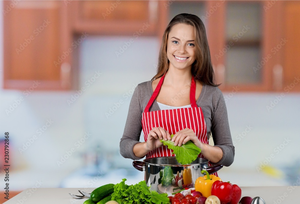 Young beautiful woman with fresh vegetables cooking Young beautiful woman with fresh vegetables cooking