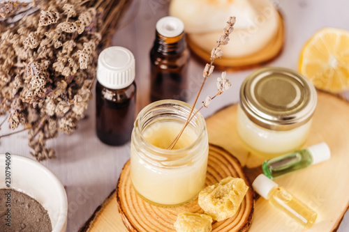 Hand cream and lip balm in a glass jar. Natural organic cosmetics with honey, wax and oils.