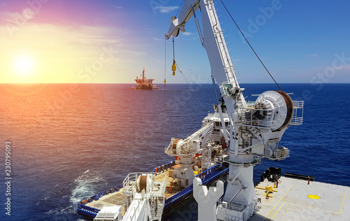 Offshore lifting operations at sea between two ships photo