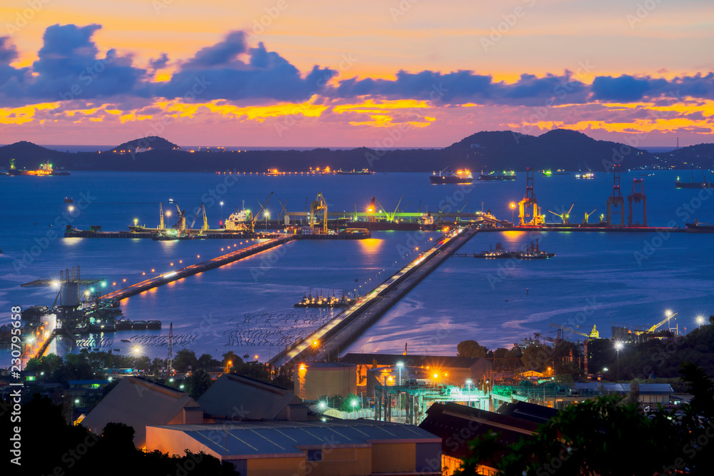 Obraz premium Laemchabang Port, Chonburi Province, Container Cargo freight ship with working crane bridge in shipyard at dusk