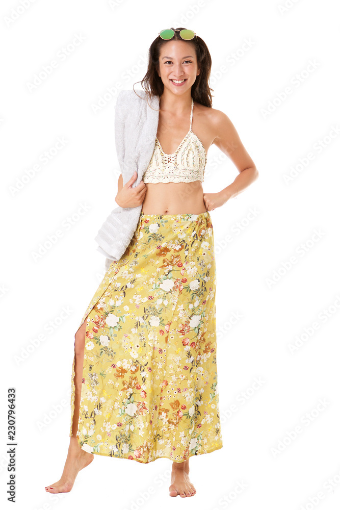 Full body young asian woman smiling in summer dress with towel against isolated white background Full body young asian woman smiling in summer dress with towel against isolated white background